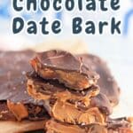 A close-up of date bark pieces generously layered with peanut butter and chocolate, elegantly stacked on a wooden surface.