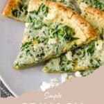 Three slices of spinach feta pizza on a white plate, topped with melted cheese and fresh spinach leaves.