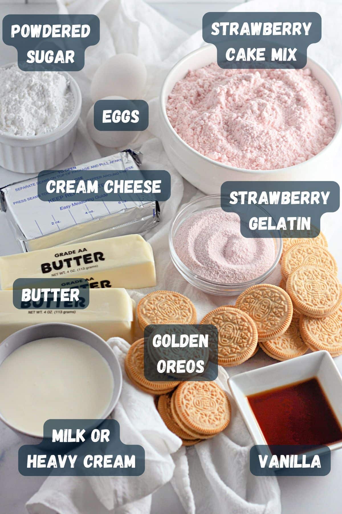 Labeled ingredients for a delightful dessert: powdered sugar, cake mix, cream cheese, gelatin, butter, Oreos, vanilla, eggs, and milk—all perfectly curated to create irresistibly creamy strawberry crunch bars that delight the senses.