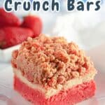 A delightful strawberry crunch bar sits on a plate, surrounded by whole strawberries in the background, creating a perfect harmony of flavors and textures.