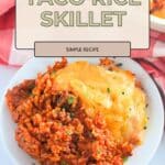 A delicious Taco Rice Skillet featuring ground beef, rice, and plenty of melted cheese on top for the perfect cheesy bite.