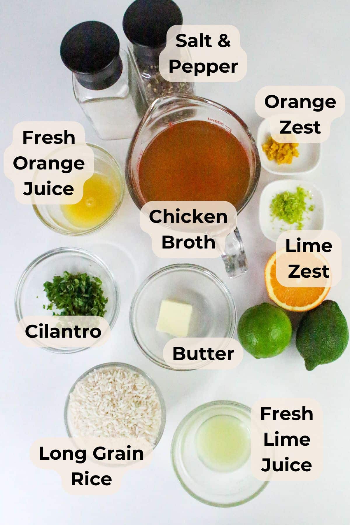 Top view of labeled Citrus Rice ingredients for a recipe, featuring rice, citrus, broth, butter, cilantro, and seasonings.