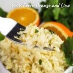 A fork with citrus rice; a bowl of vibrant Citrus Rice dotted with halved oranges in the background. Text reads: "Citrus Rice with Fresh Orange and Lime".