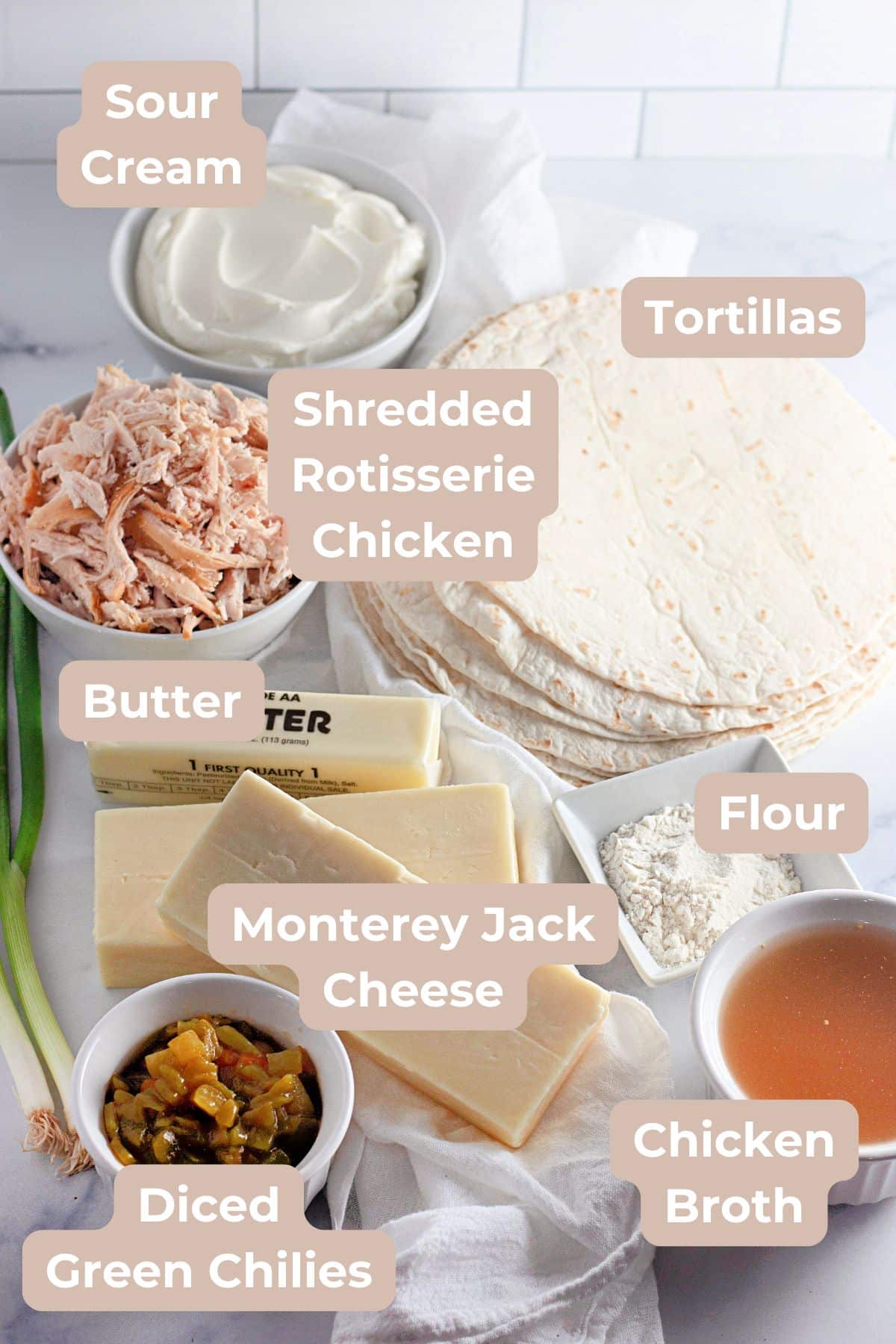 Ingredients for Chicken Enchiladas with Sour Cream Sauce include tortillas, shredded chicken, cheese, sour cream, flour, butter, broth, and chiles.