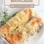 Two Chicken Enchiladas with Sour Cream Sauce on a white plate, garnished with parsley for a creamy, flavorful meal.