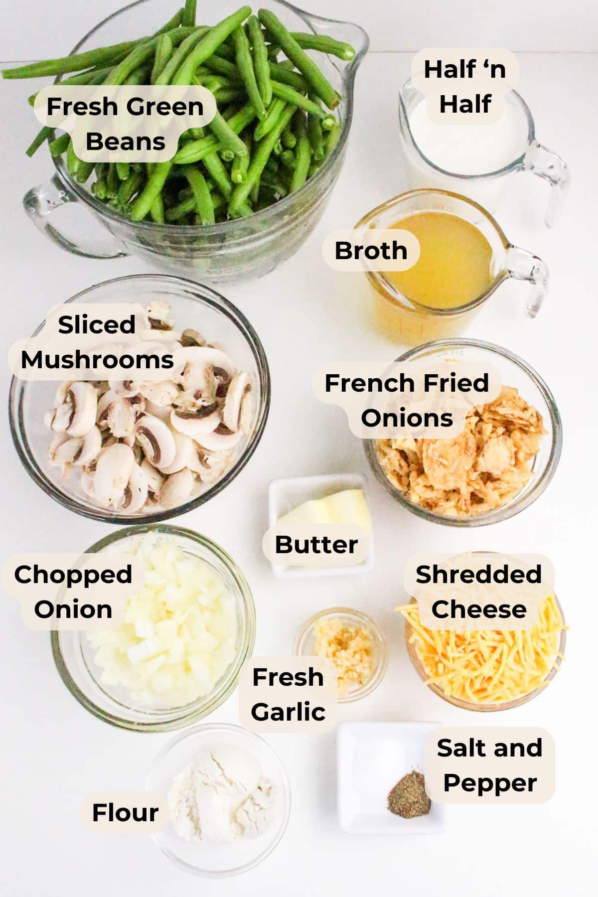 Various labeled bowls containing fresh green beans, half 'n half, broth, mushrooms, onions, cheese, and seasonings.