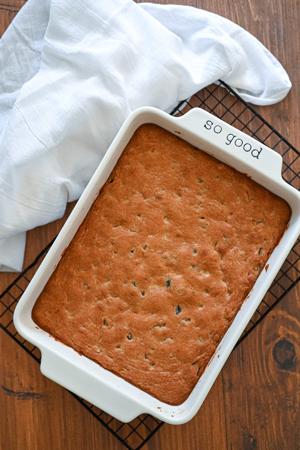 A baked cake in a white dish labeled