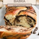 Sliced chocolate babka loaf on a white plate, with swirls of chocolate filling, labeled "easy and delicious.
