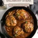 Four Ground Turkey Salisbury Steaks simmer in mushroom onion gravy in a skillet, garnished with fresh parsley.
