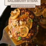 Enjoy a hearty Ground Turkey Salisbury Steak in a skillet, topped with savory mushroom onion gravy and finished with a fresh parsley garnish.
