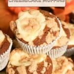 Pumpkin Cheesecake Muffins with crumb topping stacked on a plate, recipe title “Pumpkin Cheesecake Muffins” above.