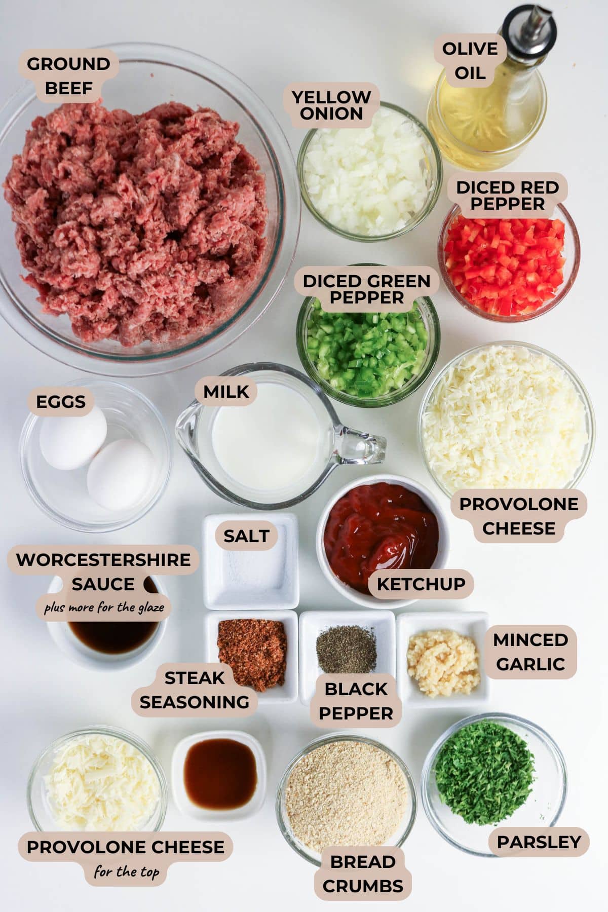 Overhead view of cheesesteak meatloaf ingredients in bowls, each with a corresponding label.