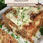 Philly cheesesteak meatloaf with a cheese filling served on a platter.
