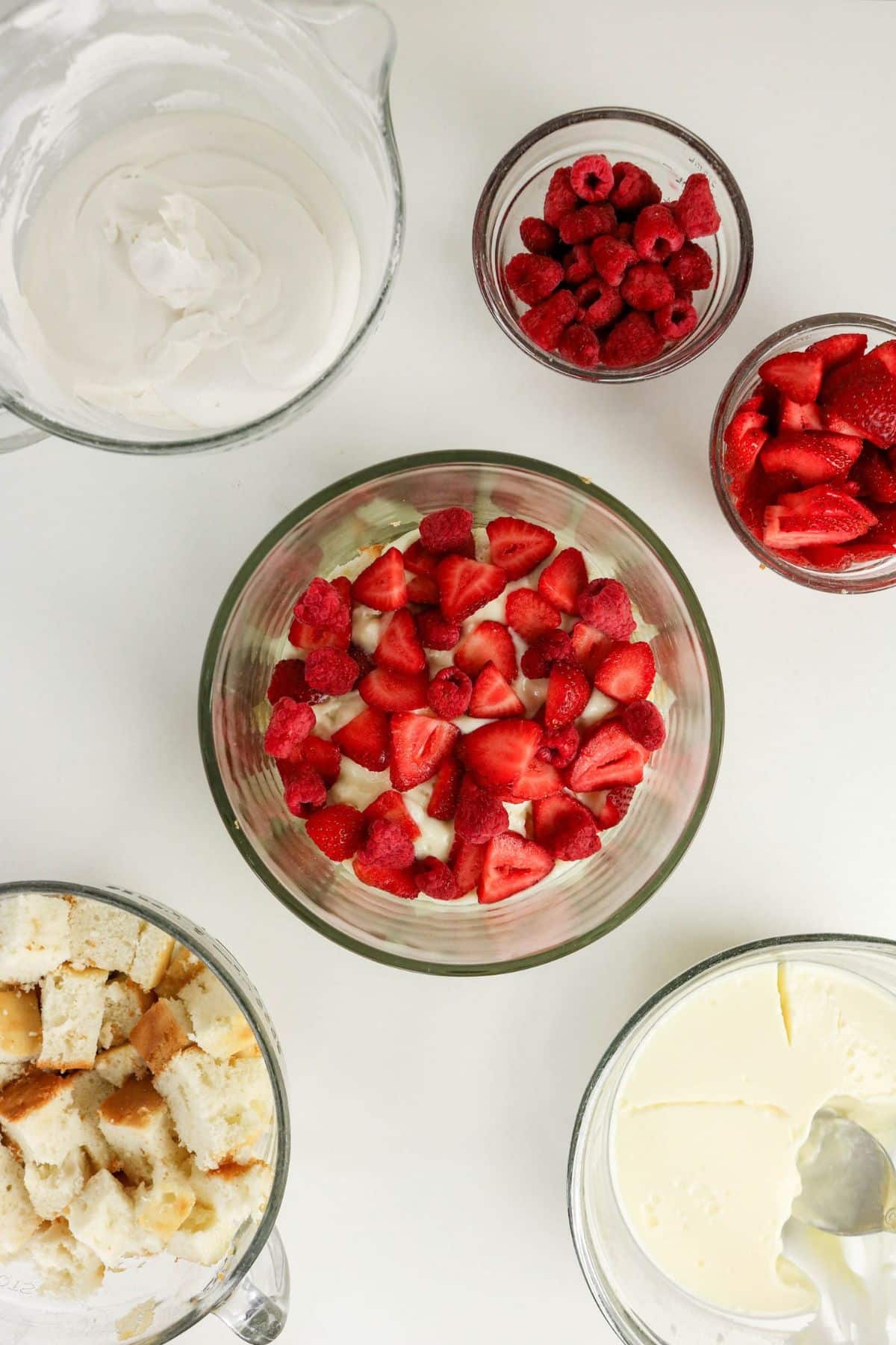 Sliced strawberries and whole raspberries pressed over the pudding layer.